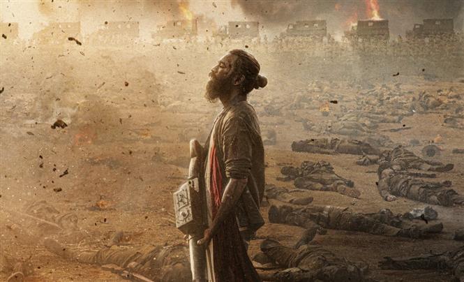 Captain Miller First Look feat. Dhanush in a war-ridden background