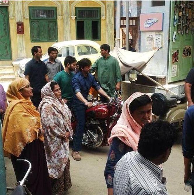 Shah Rukh Khan riding a bike on the sets of Raees